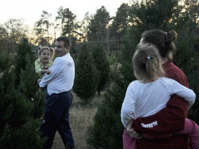 Christmas Tree Farmer Robert Wiggins Helps Families Find The Perfect Gene Sherry, left, helps family friend Marci Cochran and her children Cameron, 5, left, and Chloe, 3, pick out the perfect tree at Wiggins Christmas Tree ... - Christmas Tree Farmer Robert Wiggins Helps Families Find The Perfect